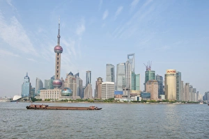 Pudong district skyline with shipping on the Huangpu River Shanghai, China Pudong district skyline with shipping on the Huangpu River Shanghai, China