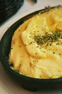Regional dish of melted cheese on an iron plate with herbs, in the restaurant El Palenque Regional dish of melted cheese on an iron plate with herbs, in the restaurant El Palenque