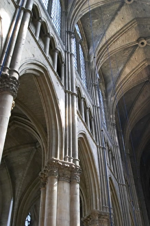 The Reims cathedral with its high gothic arched vaults and sun shining through the The Reims cathedral with its high gothic arched vaults and sun shining through the