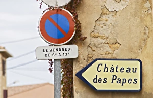 Road sign showing the way to the ruins of the chateu Popes old summer palace Road sign showing the way to the ruins of the chateu Popes old summer palace