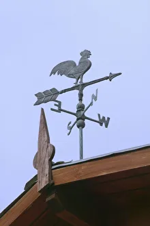 Rooster windwane on top of house, El Calafate, Argentina Rooster windwane on top of house, El Calafate, Argentina