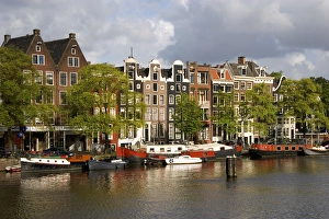 Row houses along the Amstel River in Amsterdam, Netherlands Row houses along the Amstel River in Amsterdam, Netherlands