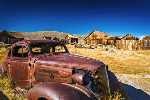 Rusted car and buildings, Bodie State Historic Park, California USA Rusted car and buildings, Bodie State Historic Park, California USA