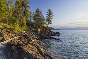 Shoreline of Flathead Lake receives sunrise light at West Shore State Park near Lakeside Shoreline of Flathead Lake receives sunrise light at West Shore State Park near Lakeside