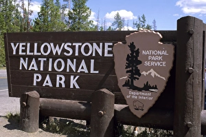 A sign at west entrance to Yellowstone National Park, Wyoming A sign at west entrance to Yellowstone National Park, Wyoming
