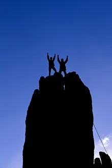 Silhouetted climbers celebrating on the summit of Eichorn Pinnacle, Yosemite National Park Silhouetted climbers celebrating on the summit of Eichorn Pinnacle, Yosemite National Park
