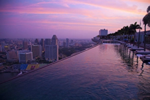 Singapore, Marina Bay Sands Hotel. Cantilevered hotel swimming pool at sunrise. Credit as Singapore, Marina Bay Sands Hotel. Cantilevered hotel swimming pool at sunrise. Credit as