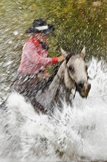 Slow motion view of cowgirl riding through water, Montana Slow motion view of cowgirl riding through water, Montana
