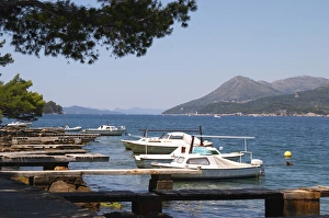 Small pleasure boats moored on jetty jetties looking out to the Kanal Daksa canal Small pleasure boats moored on jetty jetties looking out to the Kanal Daksa canal