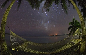 South Pacific, Cook Islands, Aitutaki. Stars rotate around the South Pole above a South Pacific, Cook Islands, Aitutaki. Stars rotate around the South Pole above a