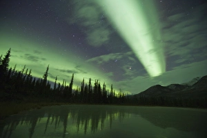 Streamers of bright green aurora borealis fill the north sky over the Brooks Range Streamers of bright green aurora borealis fill the north sky over the Brooks Range