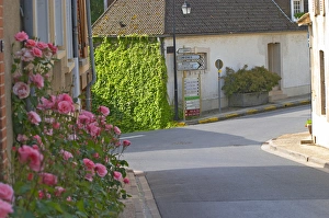 A street with village houses and road signs to Epernay, Cumieres and the Route de Champagne A street with village houses and road signs to Epernay, Cumieres and the Route de Champagne