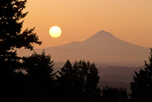 The sun hangs above Mt Hood, as viewed from Portland, Oregon The sun hangs above Mt Hood, as viewed from Portland, Oregon