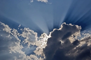 Sunbeams streaking through clouds, Masai Mara, Kenya Sunbeams streaking through clouds, Masai Mara, Kenya