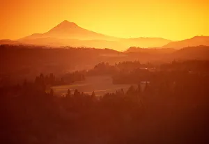 Sunrise colors the landscape in front of Mt Hood, Oregon with golden orange Sunrise colors the landscape in front of Mt Hood, Oregon with golden orange