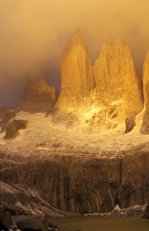 Sunrise with golden clouds on Torres del Paine in Patagonia region of Chile Sunrise with golden clouds on Torres del Paine in Patagonia region of Chile
