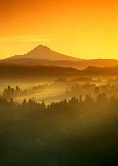 Images Dated 24th May 2005: Sunrise orange colors the fog in the valley in front of Mt Hood, Oregon, seen