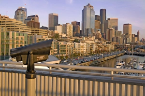 Sunset light on observation telescope and Seattle, Washington skyline from Elliot Sunset light on observation telescope and Seattle, Washington skyline from Elliot