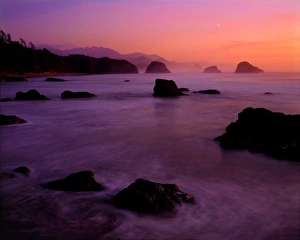 Sunset over sea stack rocks of Ecola Beach State Park looking towards Cannon Beach Sunset over sea stack rocks of Ecola Beach State Park looking towards Cannon Beach