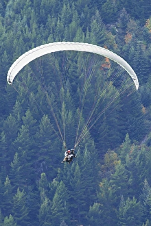 Tandem Paraglider in flight, Queenstown, South Island, New Zealand Tandem Paraglider in flight, Queenstown, South Island, New Zealand