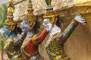 Thailand, Bangkok, Royal Palace. Yaksha (demons) guard one of the golden chedi at Thailand, Bangkok, Royal Palace. Yaksha (demons) guard one of the golden chedi at