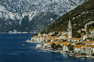 Tivat, Eastern Fjords, Montenegro. Orange tiled roofs, church and a village waterfront Tivat, Eastern Fjords, Montenegro. Orange tiled roofs, church and a village waterfront