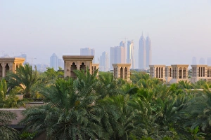 Traditional Wind Houses with modern highrises in the distance, Dubai, United Arab Traditional Wind Houses with modern highrises in the distance, Dubai, United Arab