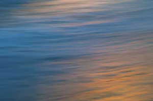 Undulating waves reflecting the sunset colors Undulating waves reflecting the sunset colors