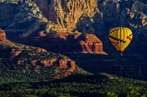 USA, Arizona. Hot-air balloon floats over Red Rocks State Park at sunset. Credit as USA, Arizona. Hot-air balloon floats over Red Rocks State Park at sunset. Credit as