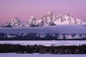 USA Colorado Grand Teton NP mountains with layer of fog at twilight USA Colorado Grand Teton NP mountains with layer of fog at twilight