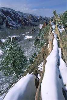 USA, Colorado, Roxborough State Park. Snow-covered redish rock formations jut against USA, Colorado, Roxborough State Park. Snow-covered redish rock formations jut against