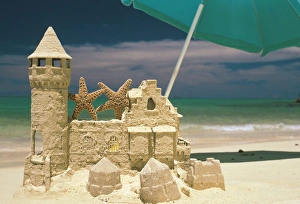 USA, Hawaii. Sandcastle and starfish on tropical beach USA, Hawaii. Sandcastle and starfish on tropical beach