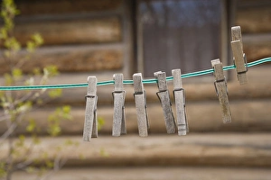 USA, Montana. Clothes pins on a clothesline outside log cabin USA, Montana. Clothes pins on a clothesline outside log cabin