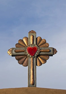 USA, New Mexico, Chimayo - Gilded cross atop of a roman catholic church in Chimayo USA, New Mexico, Chimayo - Gilded cross atop of a roman catholic church in Chimayo