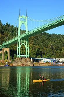 USA, Oregon, Portland, Cathedral Park, kayaker paddling under the St. Johns Bridge USA, Oregon, Portland, Cathedral Park, kayaker paddling under the St. Johns Bridge