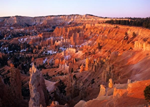 USA, Utah, Sun setting on Bryce Canyon, with snow clinging to the red cliffs USA, Utah, Sun setting on Bryce Canyon, with snow clinging to the red cliffs