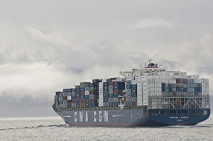 USA, WA, Laden container ship moves through Strait of Juan de Fuca with fog and clouds USA, WA, Laden container ship moves through Strait of Juan de Fuca with fog and clouds