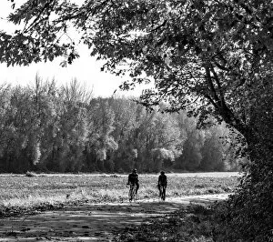 2022-08-19 Danita Delimont Dist 2325 images Collection: USA, Washington State, Fall City black and white two bike riders along Neal Rd. S. E