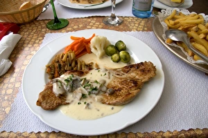 Veal with a cream sauce served at a sidewalk restaurant in Ribeauville, France Veal with a cream sauce served at a sidewalk restaurant in Ribeauville, France