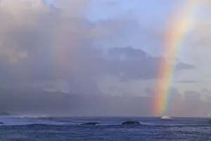 Vibrant rainbow offshore, Pacific storm waves, North Shore of Oahu, Hawaii Vibrant rainbow offshore, Pacific storm waves, North Shore of Oahu, Hawaii