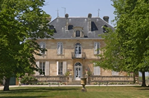 A view of the chateau building across the grass lawn in the garden Chateau Kirwan A view of the chateau building across the grass lawn in the garden Chateau Kirwan