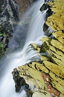 Water cascades over Rockwell Falls in Glacier National Park in Montana Water cascades over Rockwell Falls in Glacier National Park in Montana