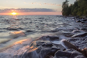 Waves crash at sunset on Devils Island in the Apostle Islands National Lakeshore Waves crash at sunset on Devils Island in the Apostle Islands National Lakeshore