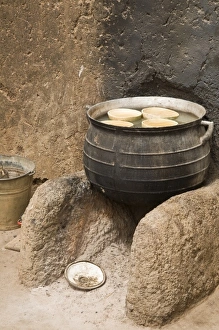 West Africa, Africa, Ghana, Nakpa. Pot on stove against wall of traditional mud dwelling West Africa, Africa, Ghana, Nakpa. Pot on stove against wall of traditional mud dwelling