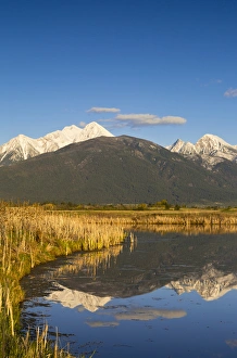 Wetlands pond reflects Mission Mountain Range at Ninepipe WMA near Ronan, Montana, USA Wetlands pond reflects Mission Mountain Range at Ninepipe WMA near Ronan, Montana, USA