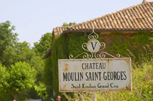 A white sign saying Chateau Moulin Saint Georges Saint Emilion Grand Cru Saint Emilion A white sign saying Chateau Moulin Saint Georges Saint Emilion Grand Cru Saint Emilion