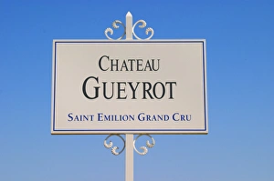 A white sign in the vineyard saying Chateau Gueyrot Saint Emilion Grand Cru Saint A white sign in the vineyard saying Chateau Gueyrot Saint Emilion Grand Cru Saint