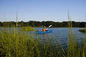 A woman kayaks in the Black Hall River near the mouth of the Connecticut River in Old Lyme A woman kayaks in the Black Hall River near the mouth of the Connecticut River in Old Lyme
