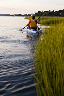 A woman kayaks in a marshy section of the Connecticut River in Old Lyme, Connecticut A woman kayaks in a marshy section of the Connecticut River in Old Lyme, Connecticut