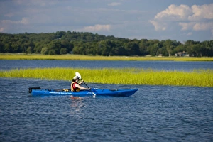 A woman kayaks near the mouth of the Connecticut River in Old Lyme, Connecticut A woman kayaks near the mouth of the Connecticut River in Old Lyme, Connecticut